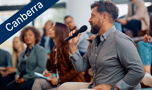 Man speaking into microphone at an event