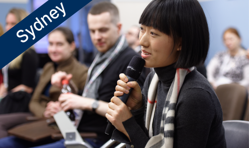 Women asking a question holding a microphone